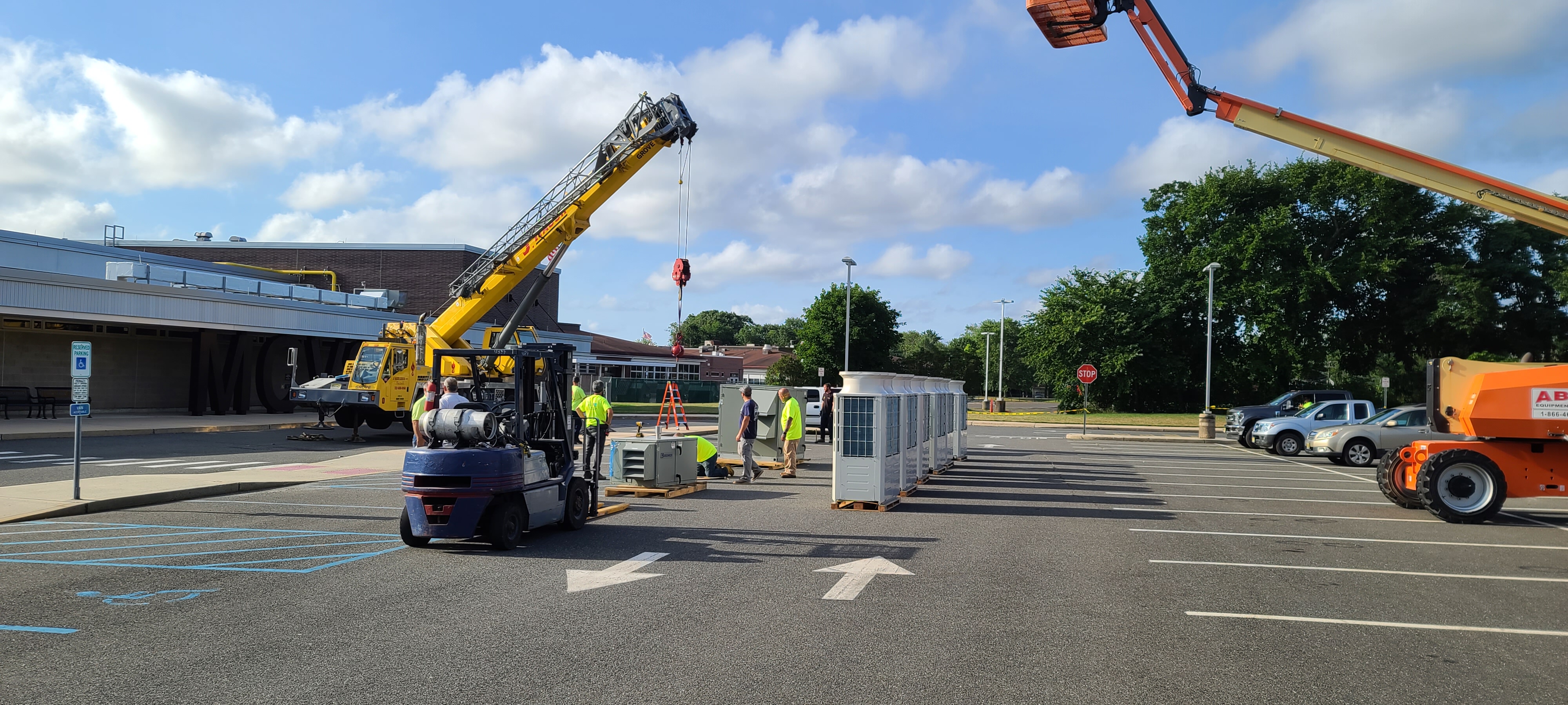 Crew preparing HVAC equipment for installation